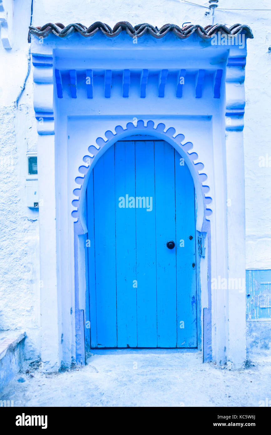 Traditional powder blue painted house facade and door in the historical Medina of Chefchaouen, Morocco Stock Photo