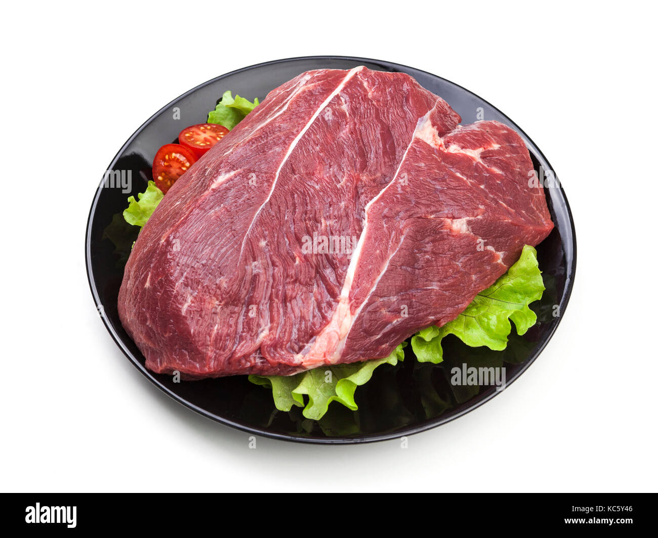 Piece of raw beef on plate isolated on white background Stock Photo - Alamy