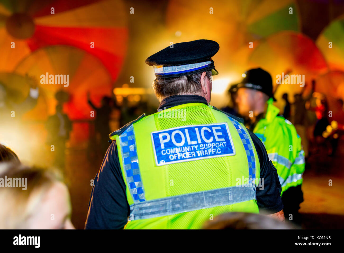 Police officer against a colourful smoke festival background providing ...