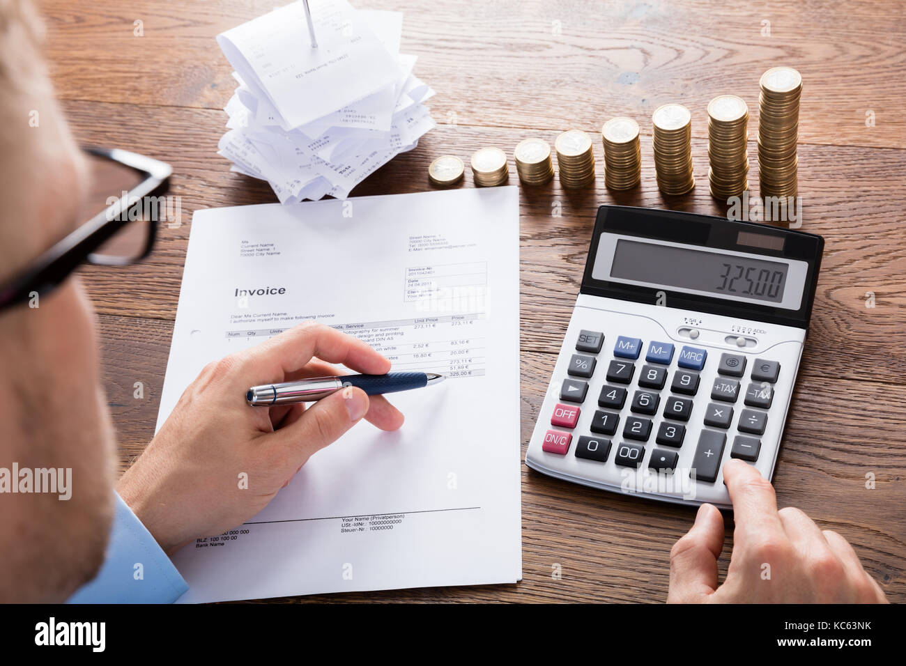 Accountant Calculating Tax Using Calculator On Wooden Desk. save Money Concept Stock Photo