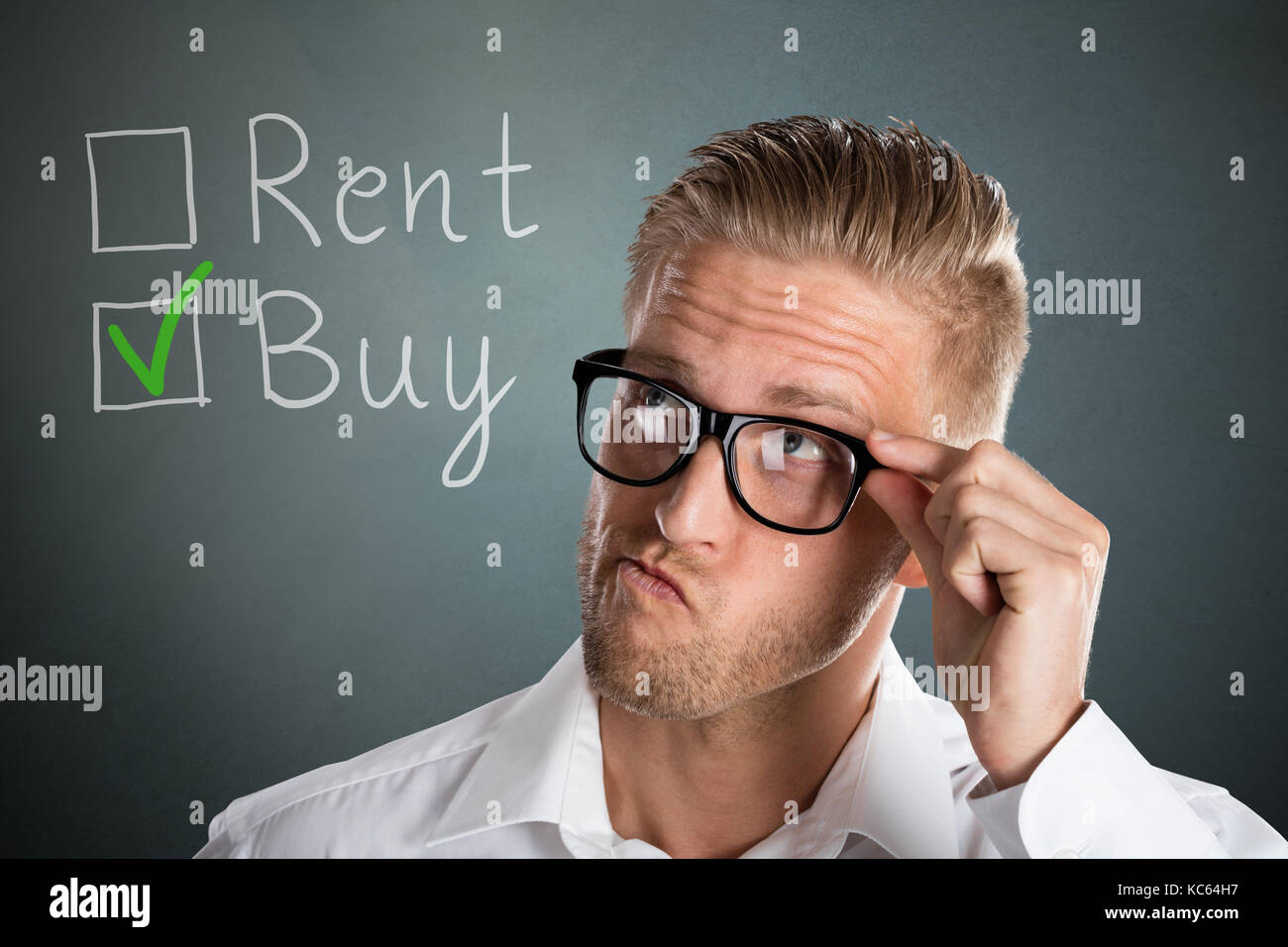 Young Handsome Business Man Choosing Rent Or Buy Option For Real Estate Property Stock Photo