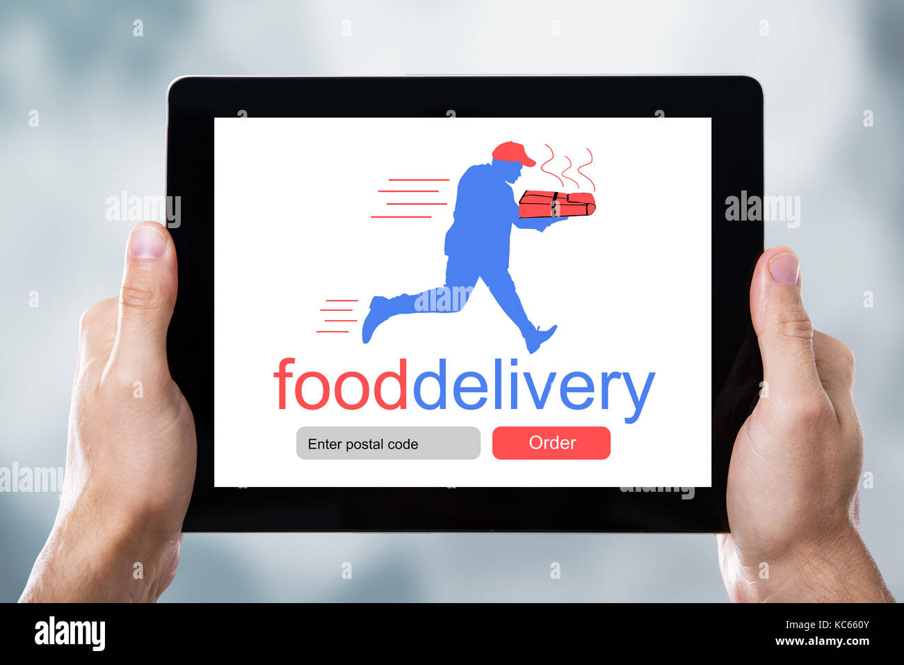 Close-up Of A Man's Hand Holding Digital Tablet Showing Food Delivery Application On A Screen Stock Photo
