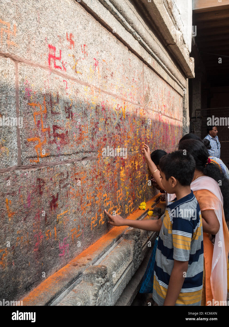 Hindu pilgrims painting swastikas in Chamundeshwari Temple, Mysore Stock Photo