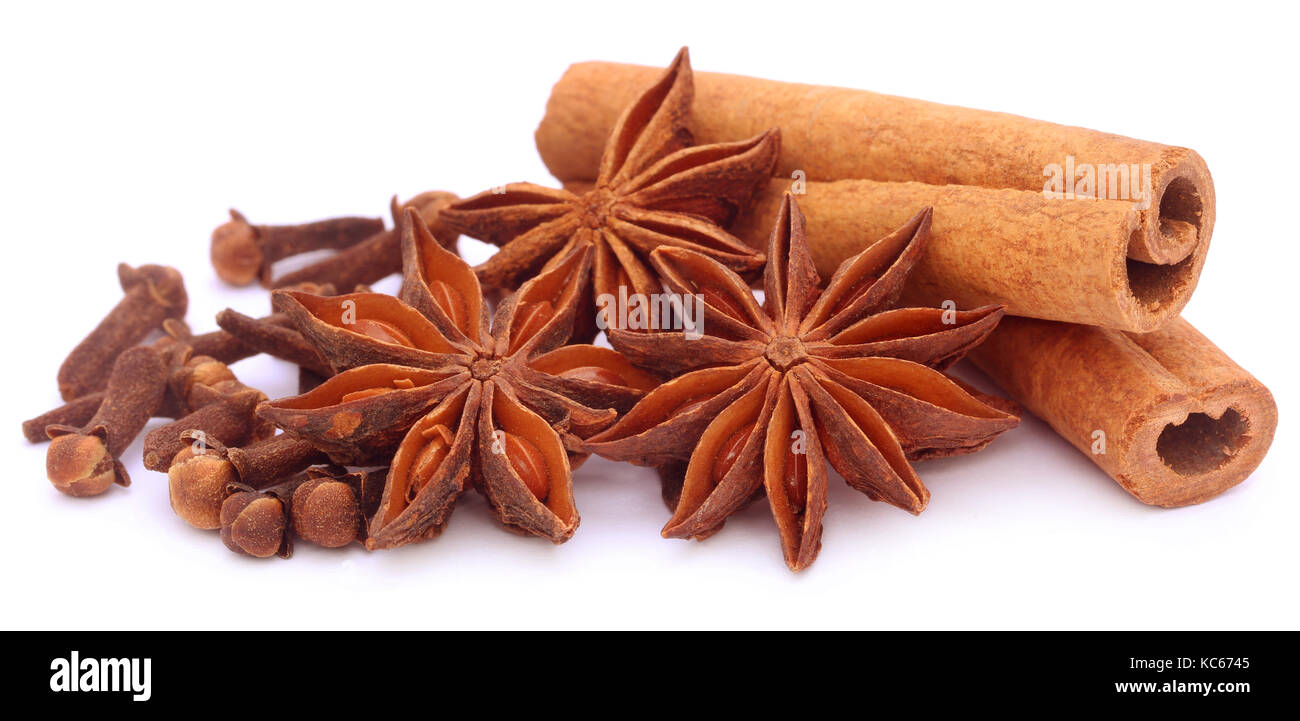 Some aromatic cinnamon with star anise and cloves over white background Stock Photo