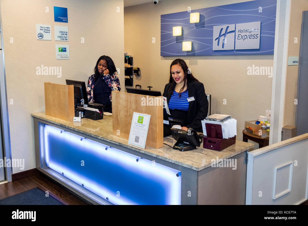 Maryland,Silver Spring,Holiday Inn Express,hotel,front desk check in reception reservation reservations register registration,Black woman female women Stock Photo