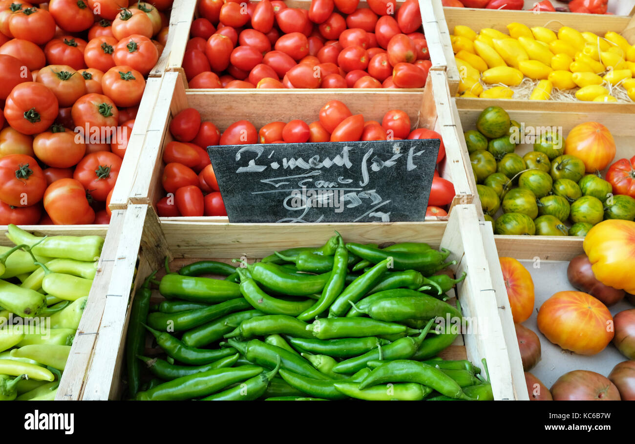 Market stall selling tomatoes and chillis in Provenge, France Stock Photo