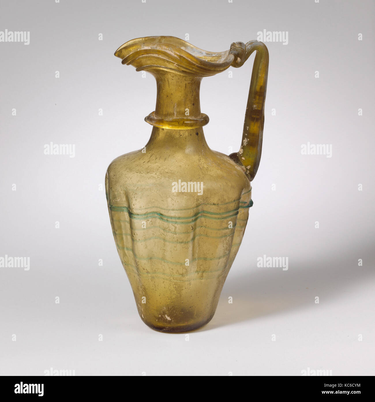 Glass jug with trefoil rim, Late Imperial, 4th–5th century A.D., Roman, Glass; blown, tooled, and trailed, H. 5 3/16 in. (13.2 Stock Photo