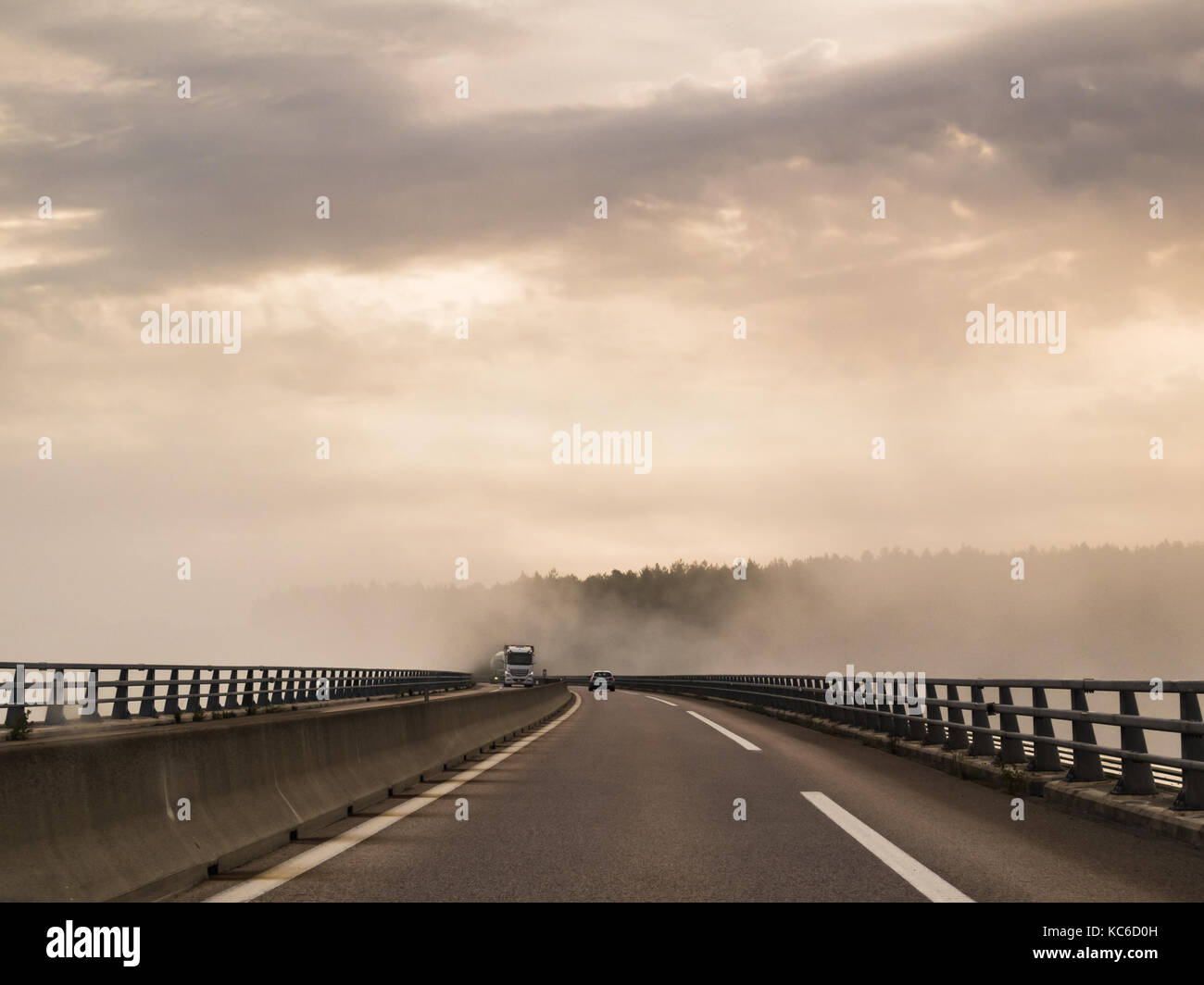 Misty, foggy morning causing difficult driving conditions on a road