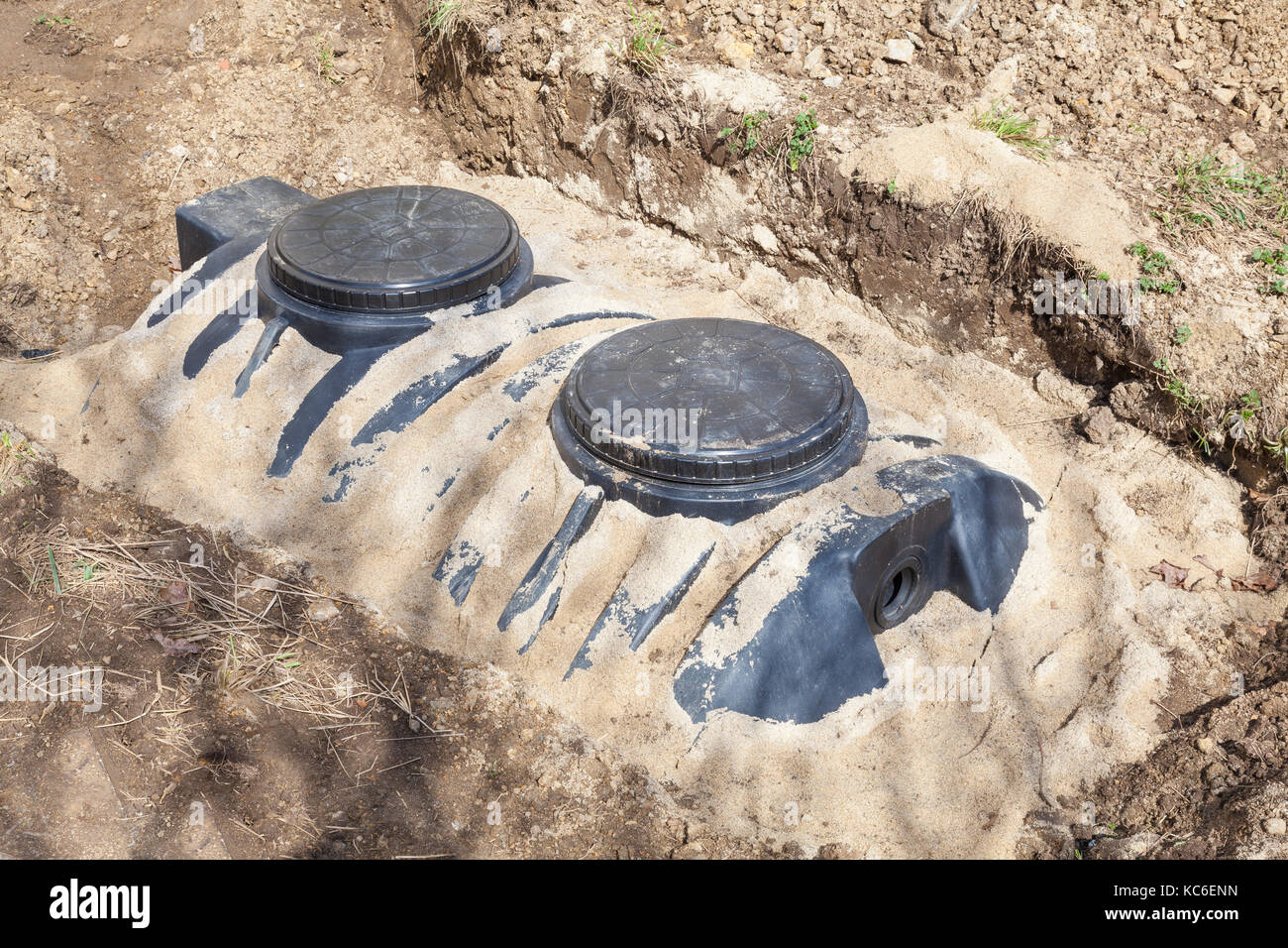 New domestic septic tank installation for the disposal and purification of household effluent, sewage and wastewater showing a tank in  a sand bed Stock Photo