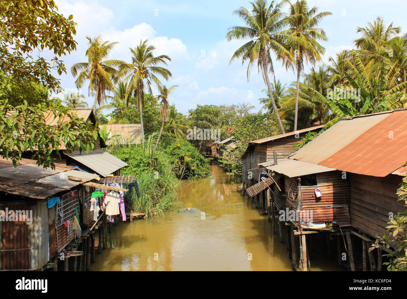 huts at river in tropical landscape - houses in jungle Stock Photo