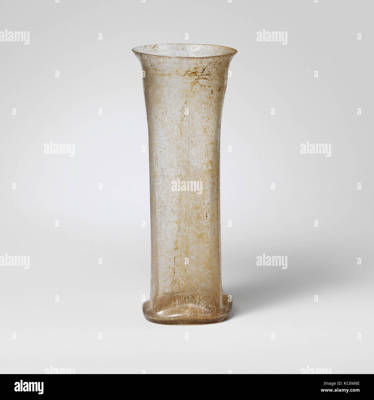 Glass beaker, Mid Imperial, 2nd–3rd century A.D., Roman, Glass; blown and cut, Overall: 5 5/8in. (14.3cm), Glass, Tall, slender Stock Photo