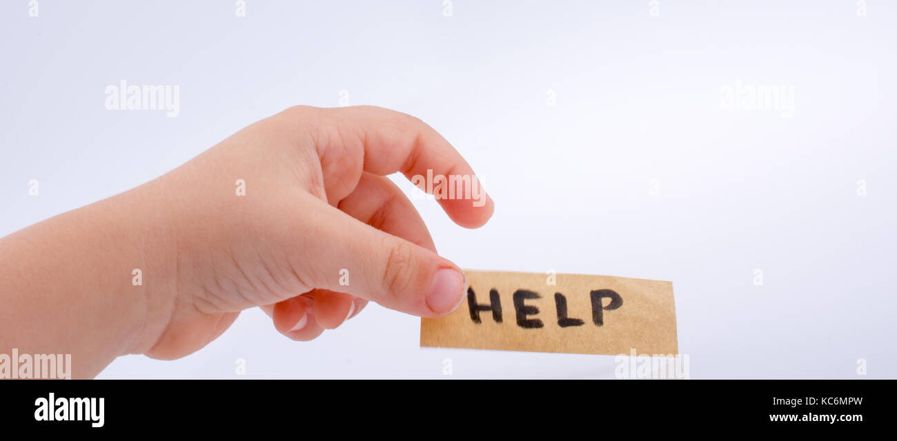Help word on a piece paper in hand Stock Photo - Alamy