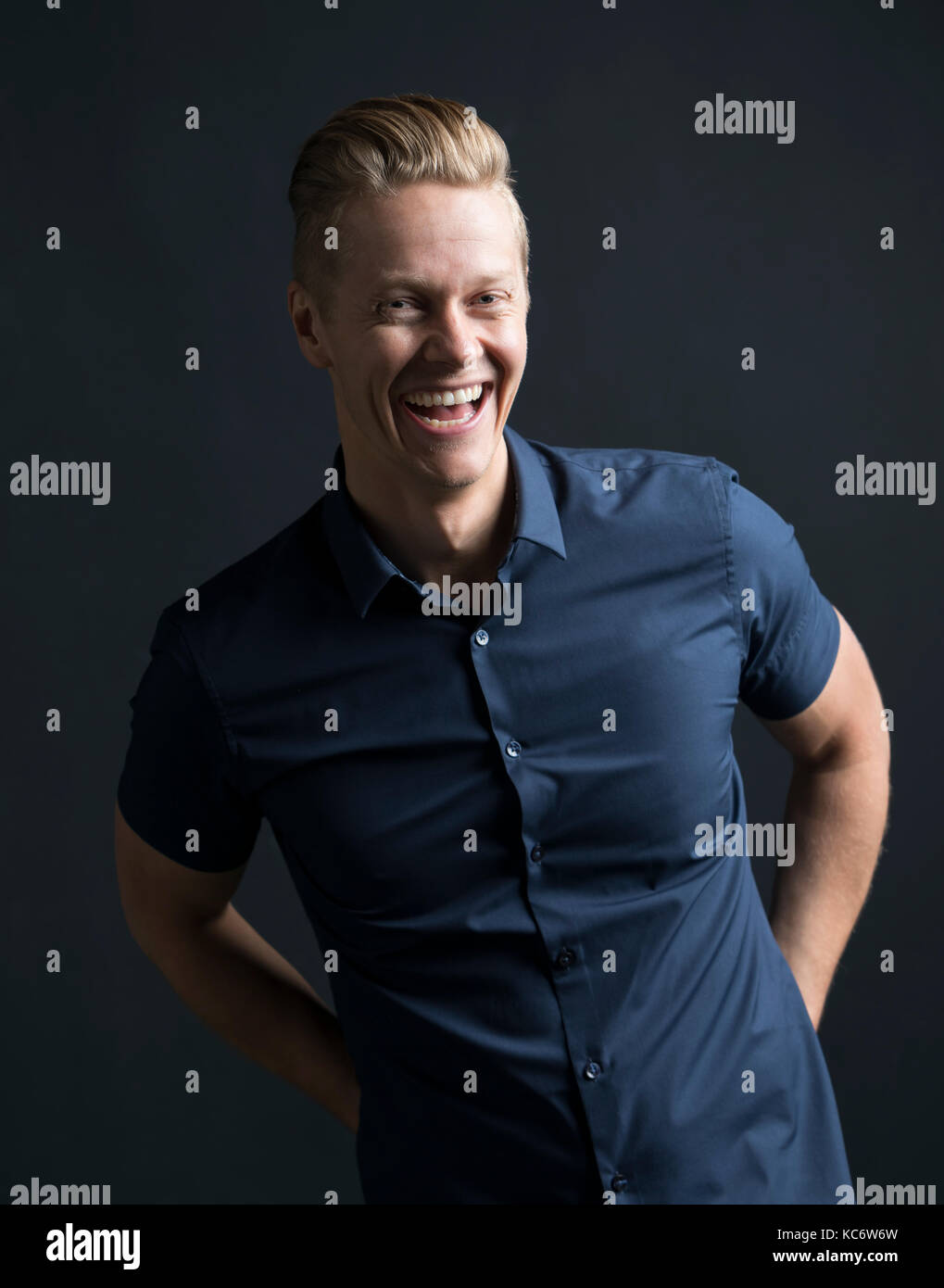 Portrait of blond man laughing Stock Photo