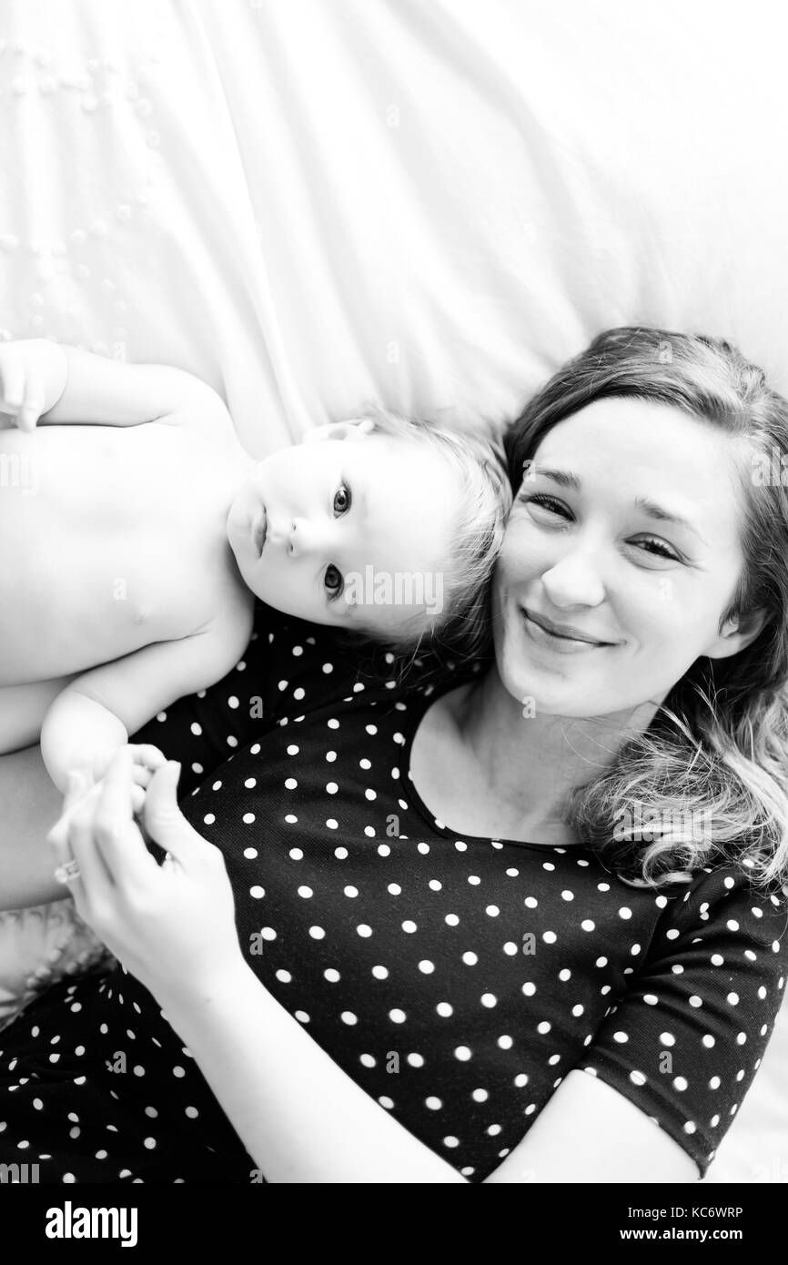 Portrait of baby girl (6-11 Months) with mother, directly above Stock Photo