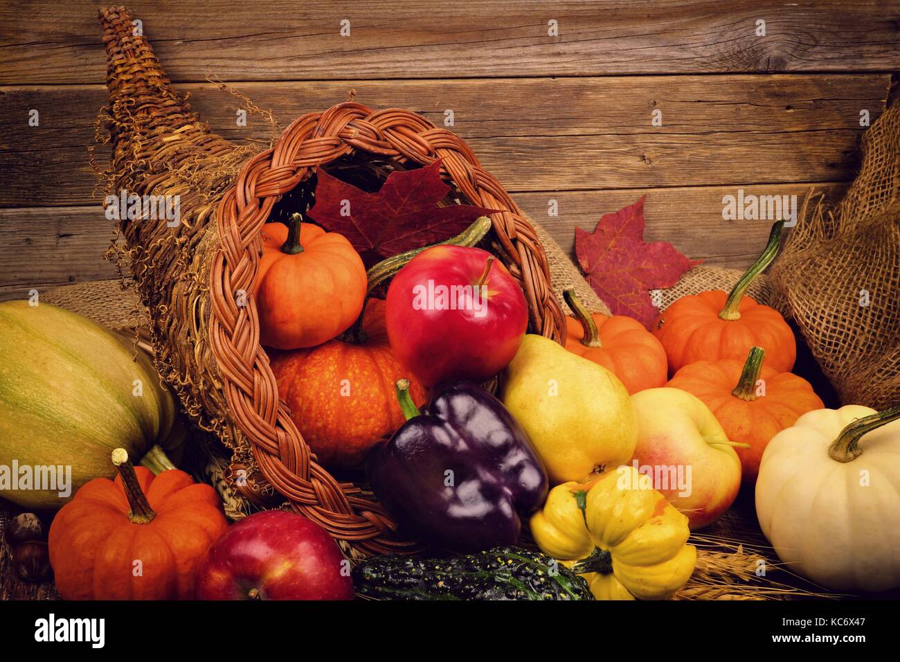 Thanksgiving cornucopia close up against a rustic wooden background Stock Photo