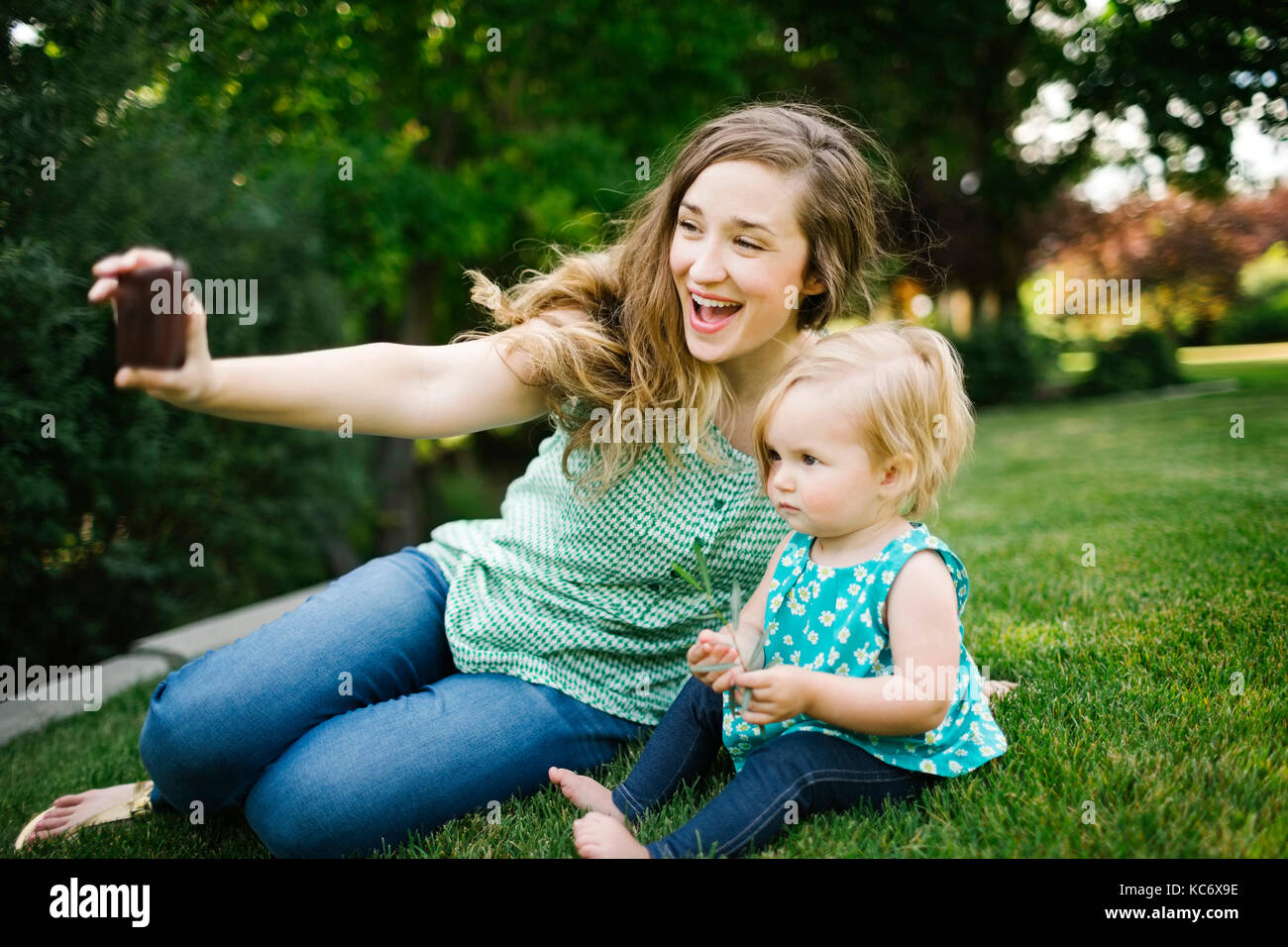 Mother taking selfie with daughter (12-17 months) Stock Photo