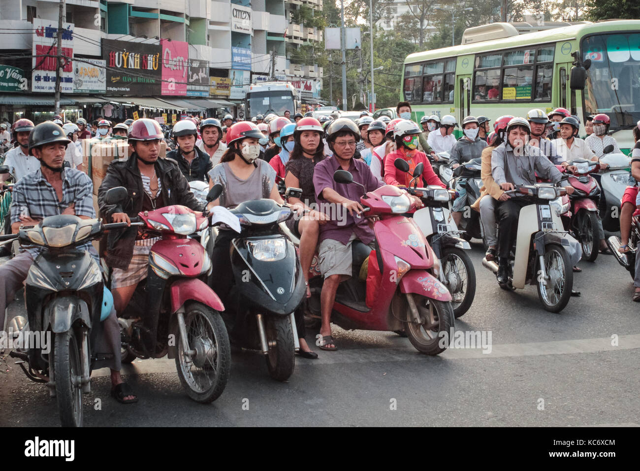 Saigon, Vietnam - January 2017: Many scooter driver and motorbikes at traffic light on Saigon street. Stock Photo