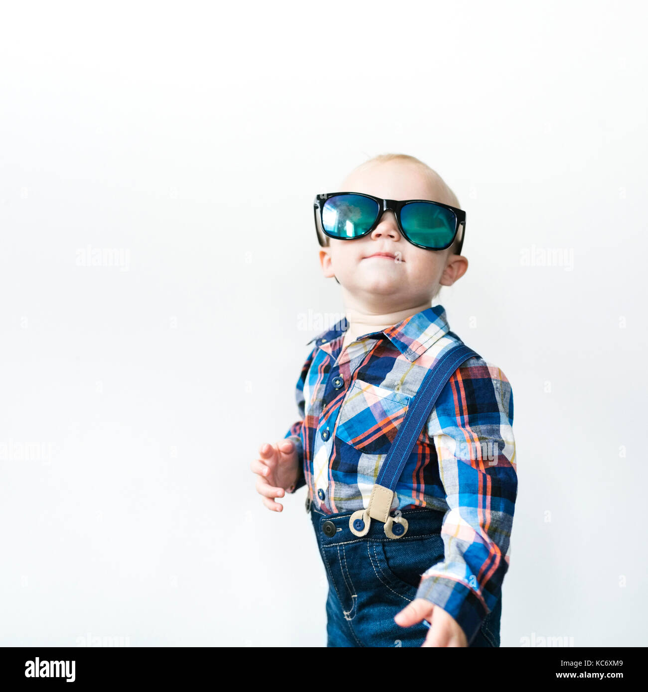 Studio shot of baby boy (12-17 months) wearing sunglasses Stock Photo