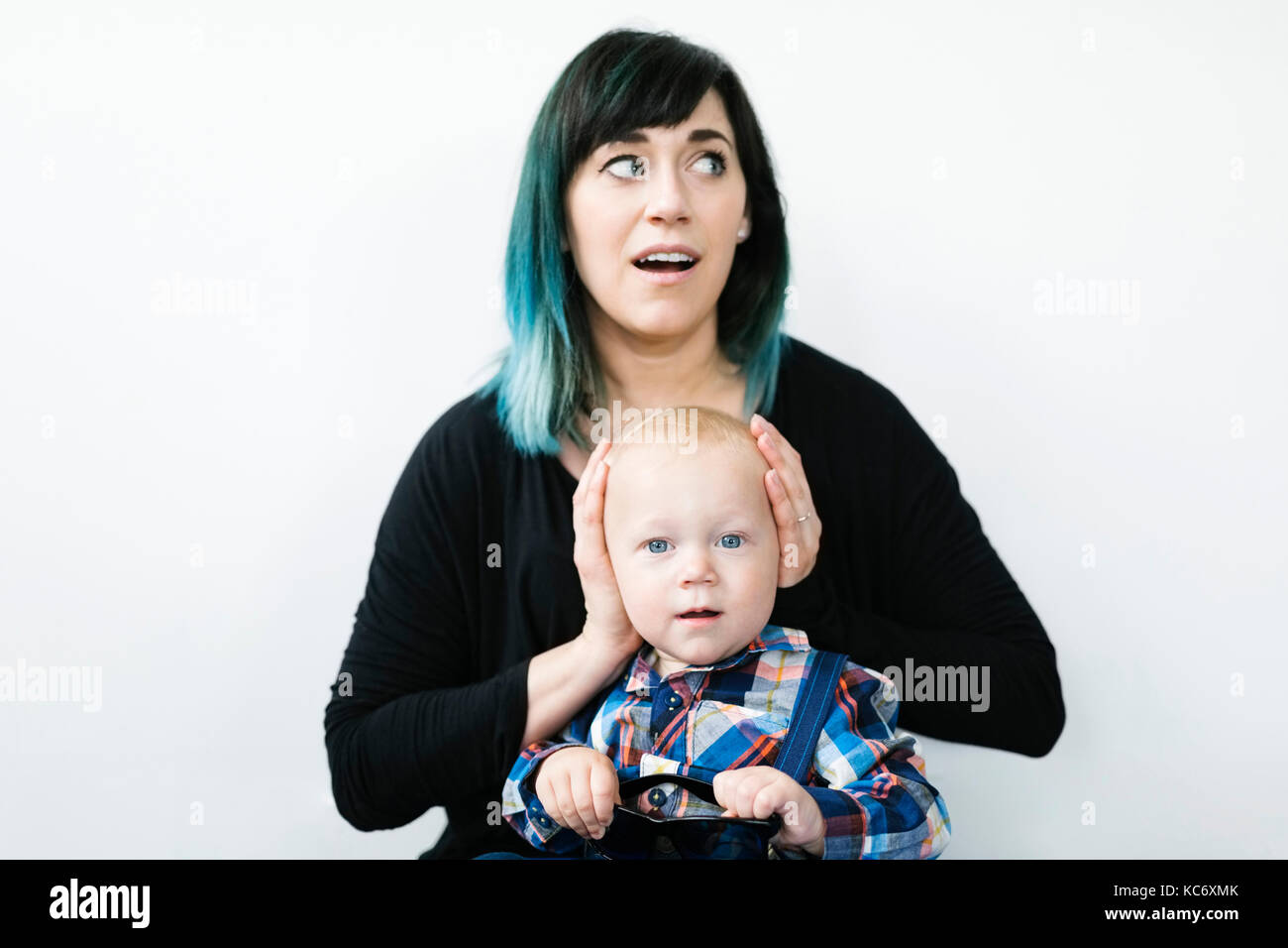 Mother covering son's ears (1217 months Stock Photo Alamy