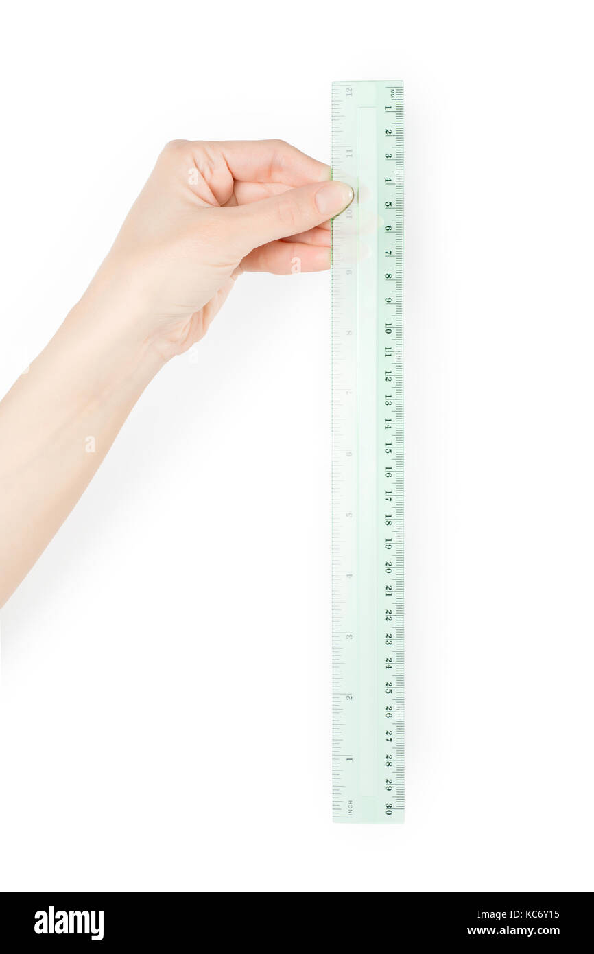 Woman hand measuring something with green ruler. Isolated on white, clipping path included Stock Photo