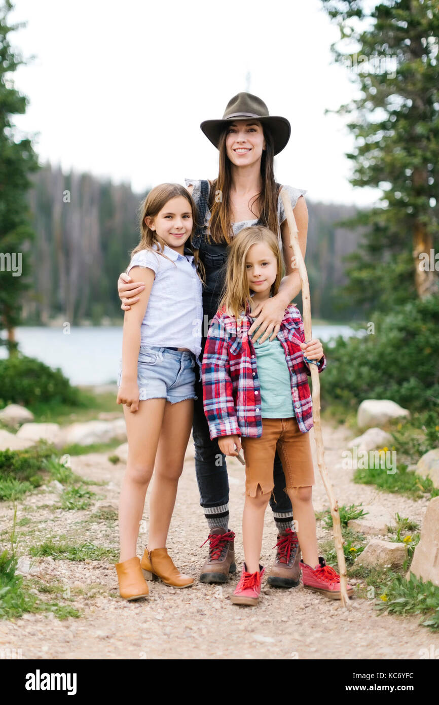 Outdoor portrait of mother with kids (6-7, 8-9) in forest Stock Photo