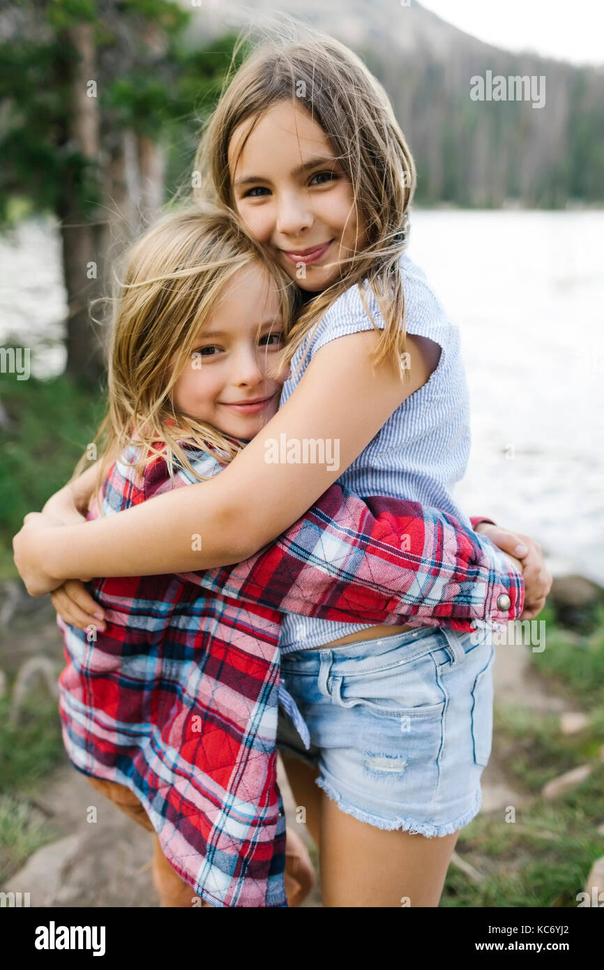 Brother and sister hugging in forest Stock Photo - Alamy