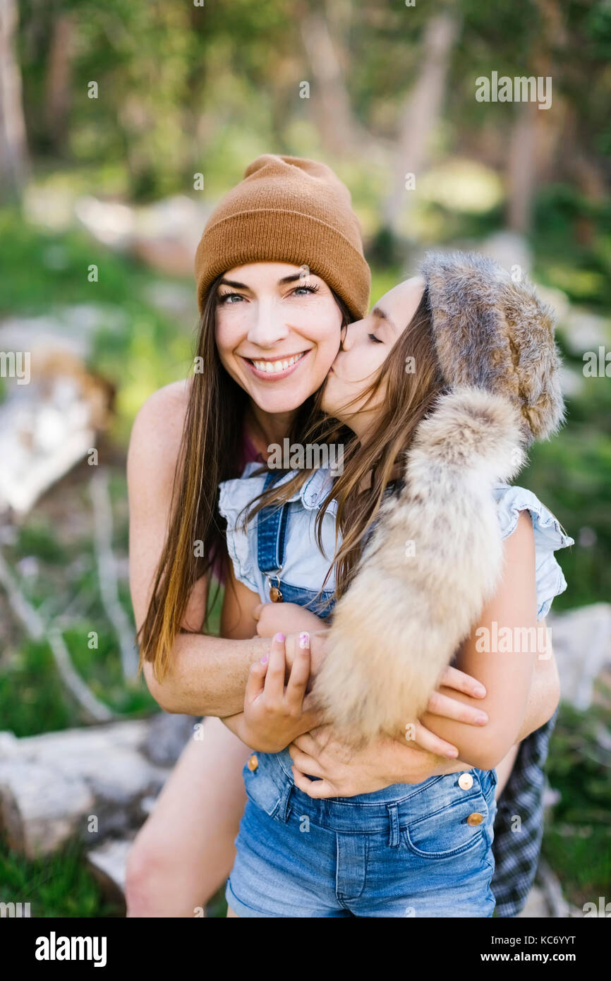 Portrait of mother with daughter (8-9) hiking in forest Stock Photo