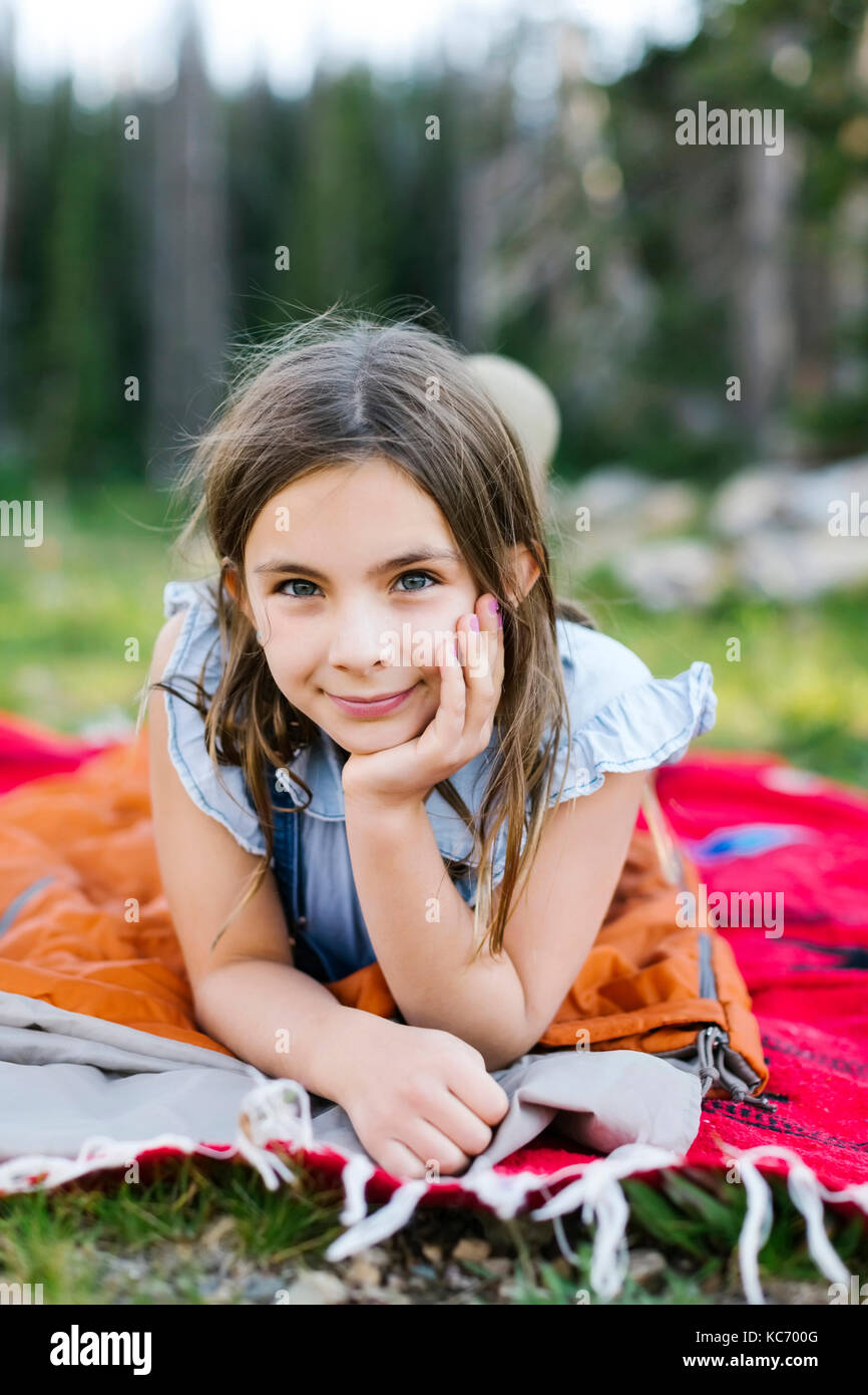 Girl lying on blanket in hi-res stock photography and images