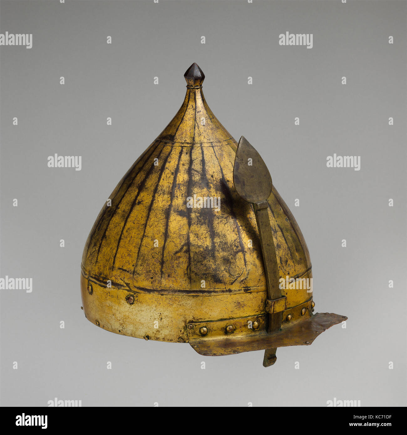 Helmet, late 16th century, Turkish, Copper alloy (tombak), gold, leather, textile, H. including nasal 14 1/4 in. (36.2 cm); H Stock Photo