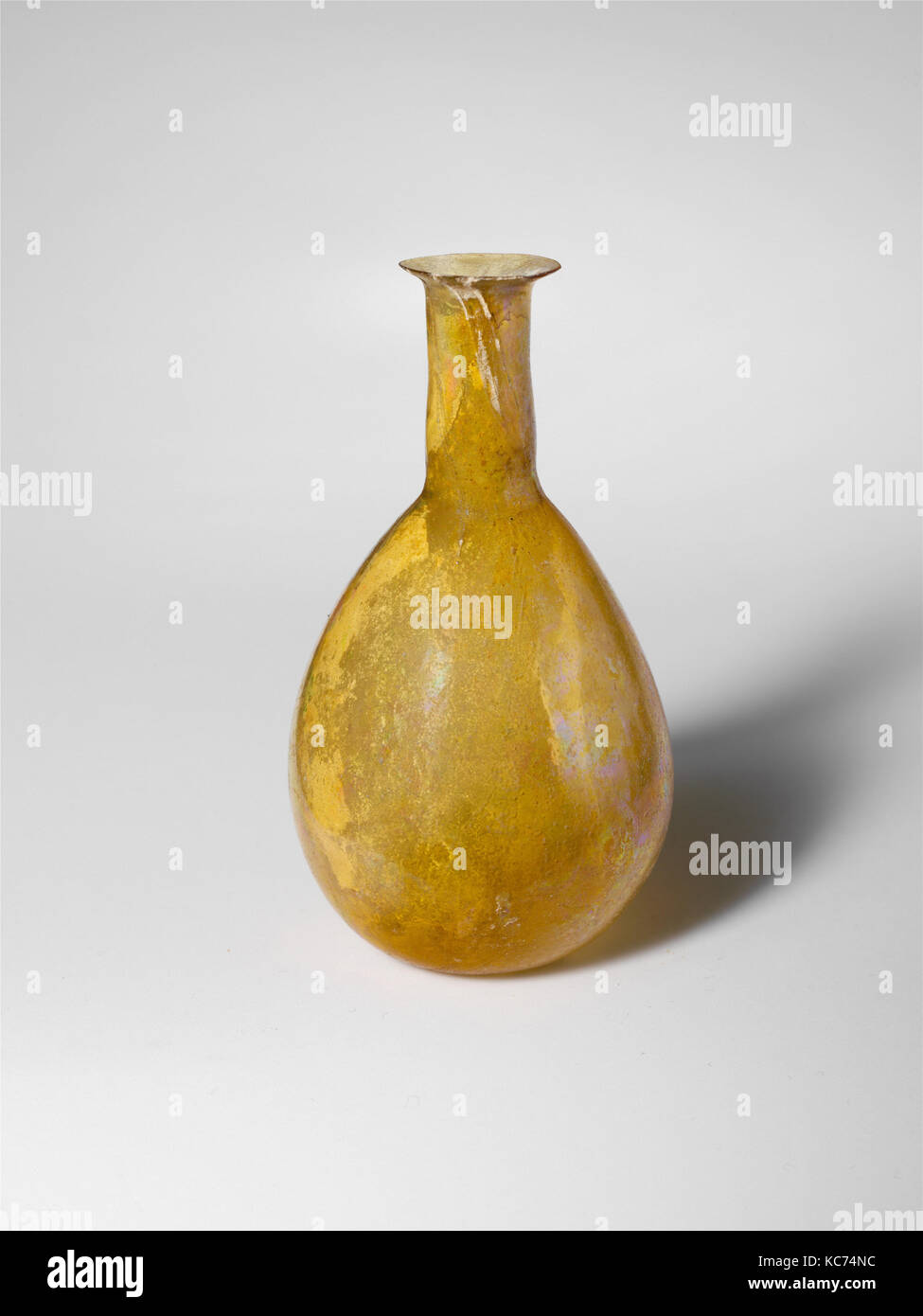 Glass perfume bottle, Early Imperial, 1st century A.D., Roman, Glass; blown, H.: 2 9/16 in. (6.5 cm), Glass, Translucent yellow Stock Photo