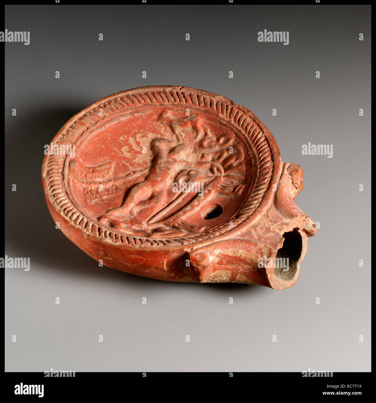 Lamp, Roman, Terracotta, Overall: 1 1/4 x 3 5/8 in. (3.2 x 9.2 cm), Terracottas Stock Photo