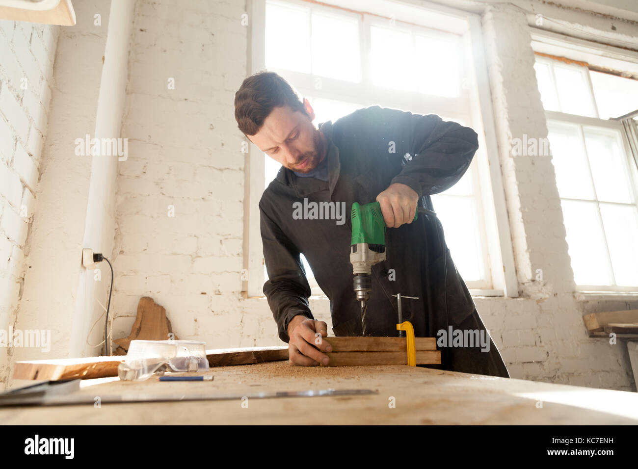 Young man using drill machine hi-res stock photography and images - Alamy
