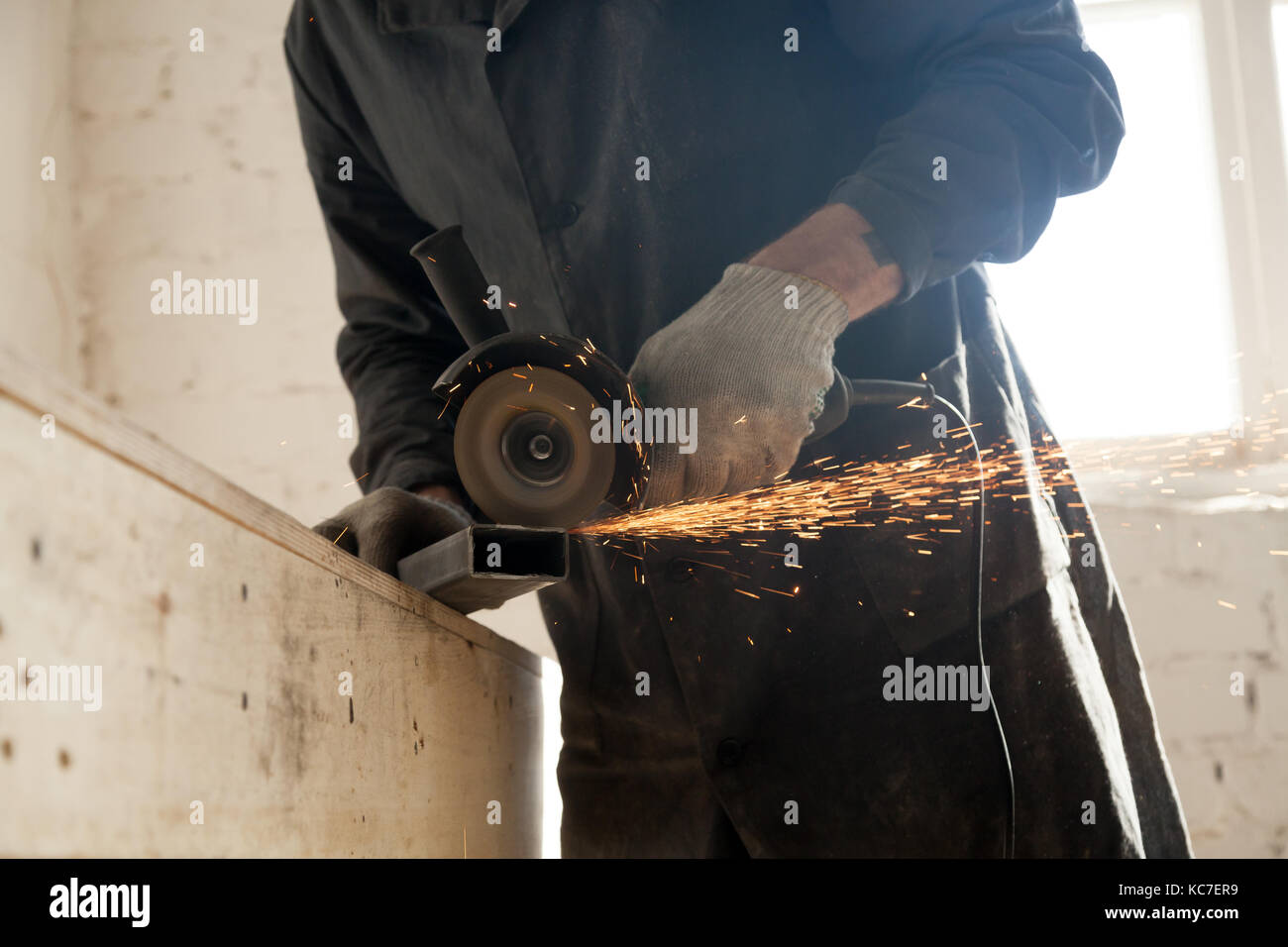 Close up of cutting metal pipe, man using angle grinder Stock Photo Alamy