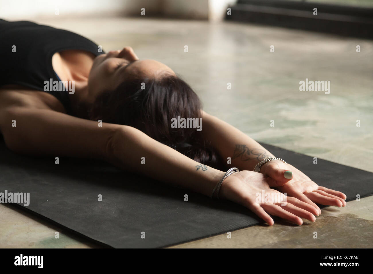 Young attractive woman stretching on the floor Stock Photo - Alamy