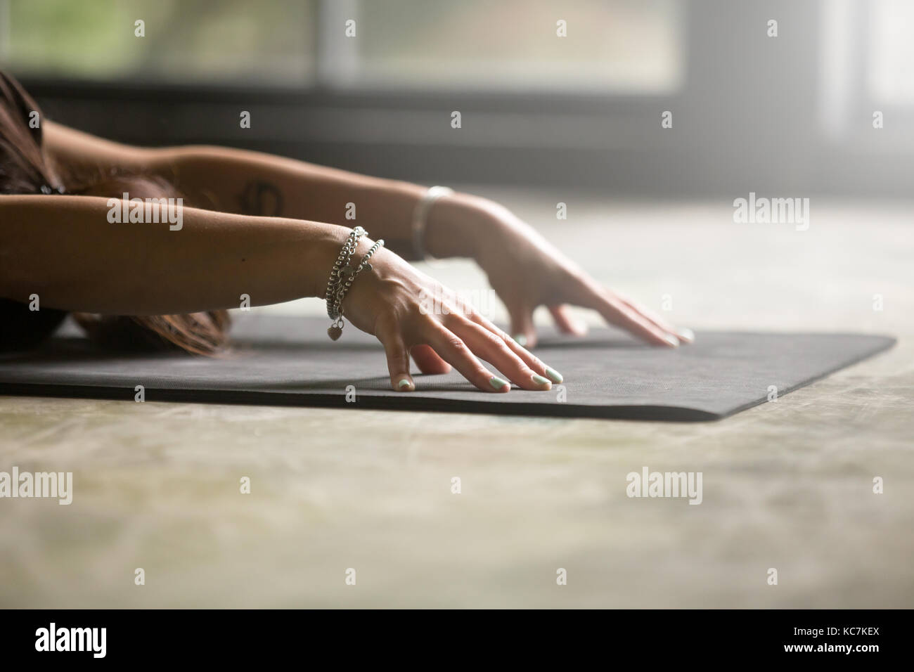 Close up of female hands, Child pose Stock Photo