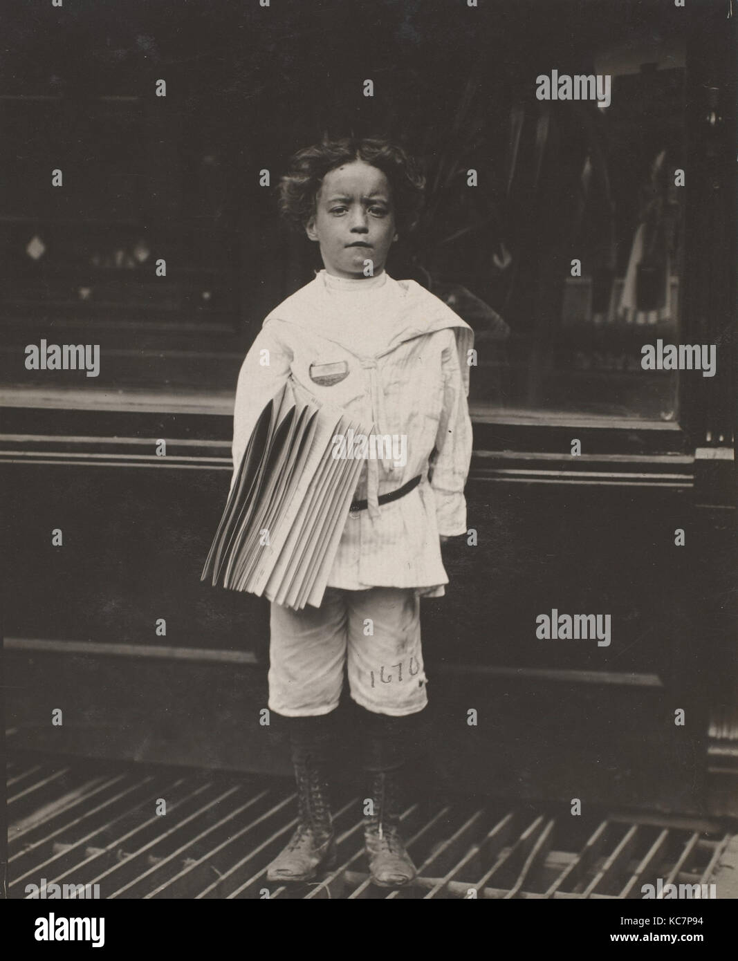Jo Lehman, a 7 year old newsboy. 824 Third Ave., N.Y. City. He was selling in this Saloon Stock Photo