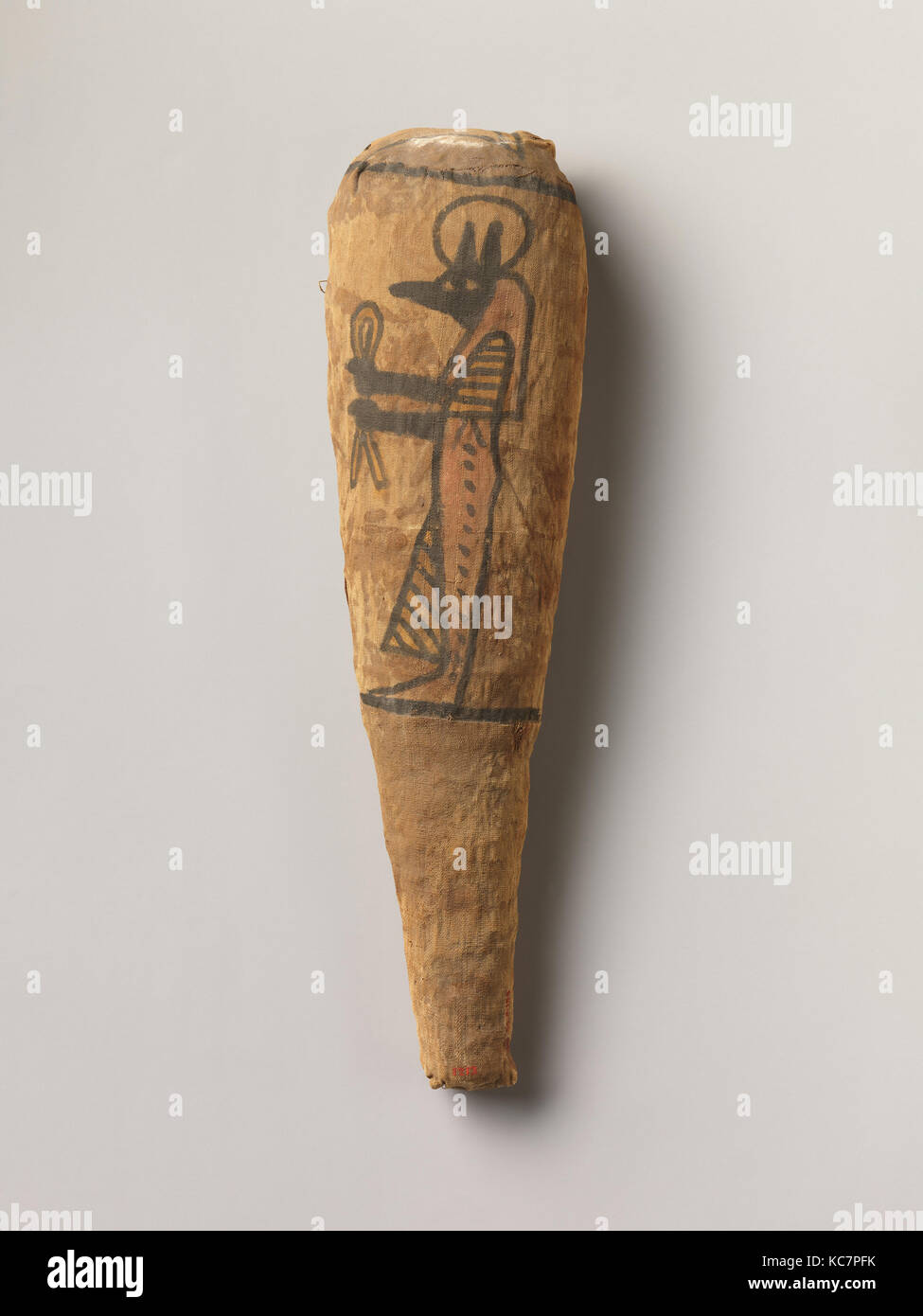 Sacred animal mummy in the form typical of a wrapped ibis, decorated with a figure of Duamutef, ca. 400 B.C.–100 A.D Stock Photo
