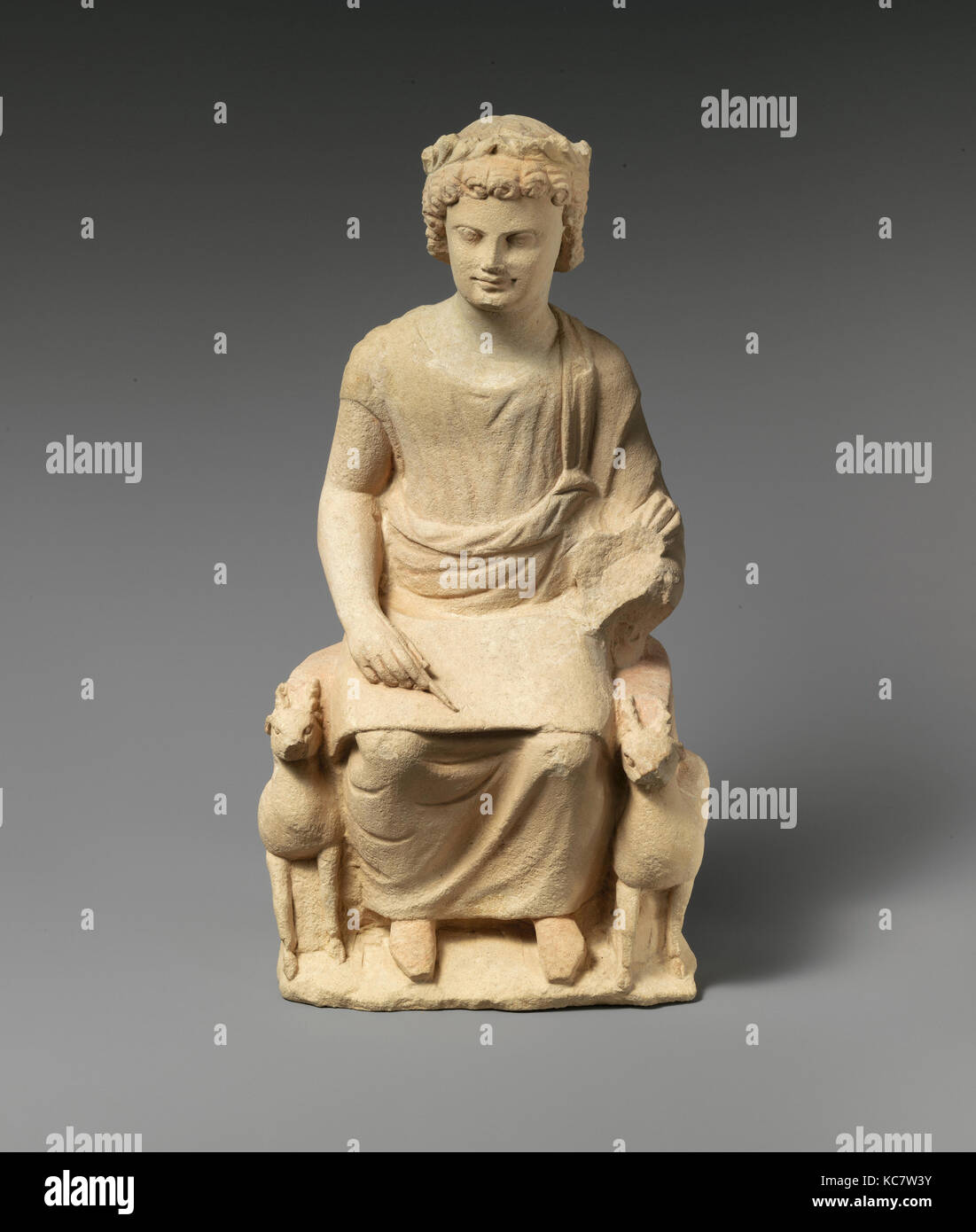 Limestone statue of an enthroned youth, 3rd century B.C Stock Photo