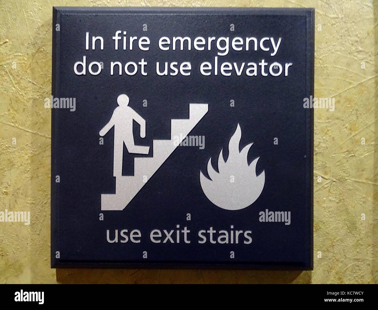 A sign advising to use the stairs instead of the elevator Stock Photo