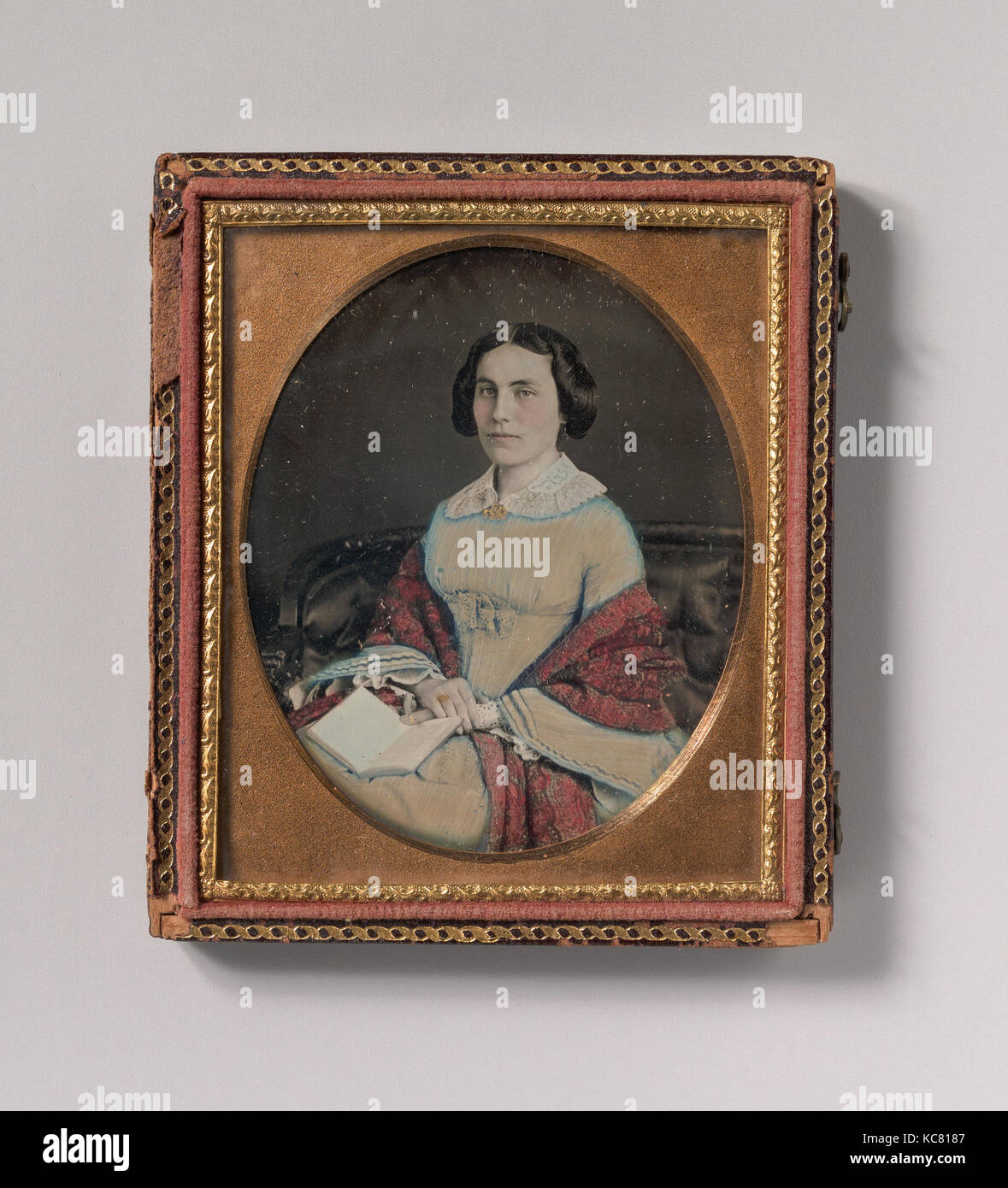 Seated Young Woman Wearing a Shawl, Holding an Open Book in her Lap, Unknown, 1850s Stock Photo