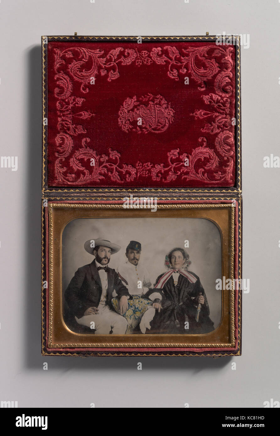 Two Men, One in Military Garb, and a Woman, Seated Around a Table, Unknown, 1860s Stock Photo