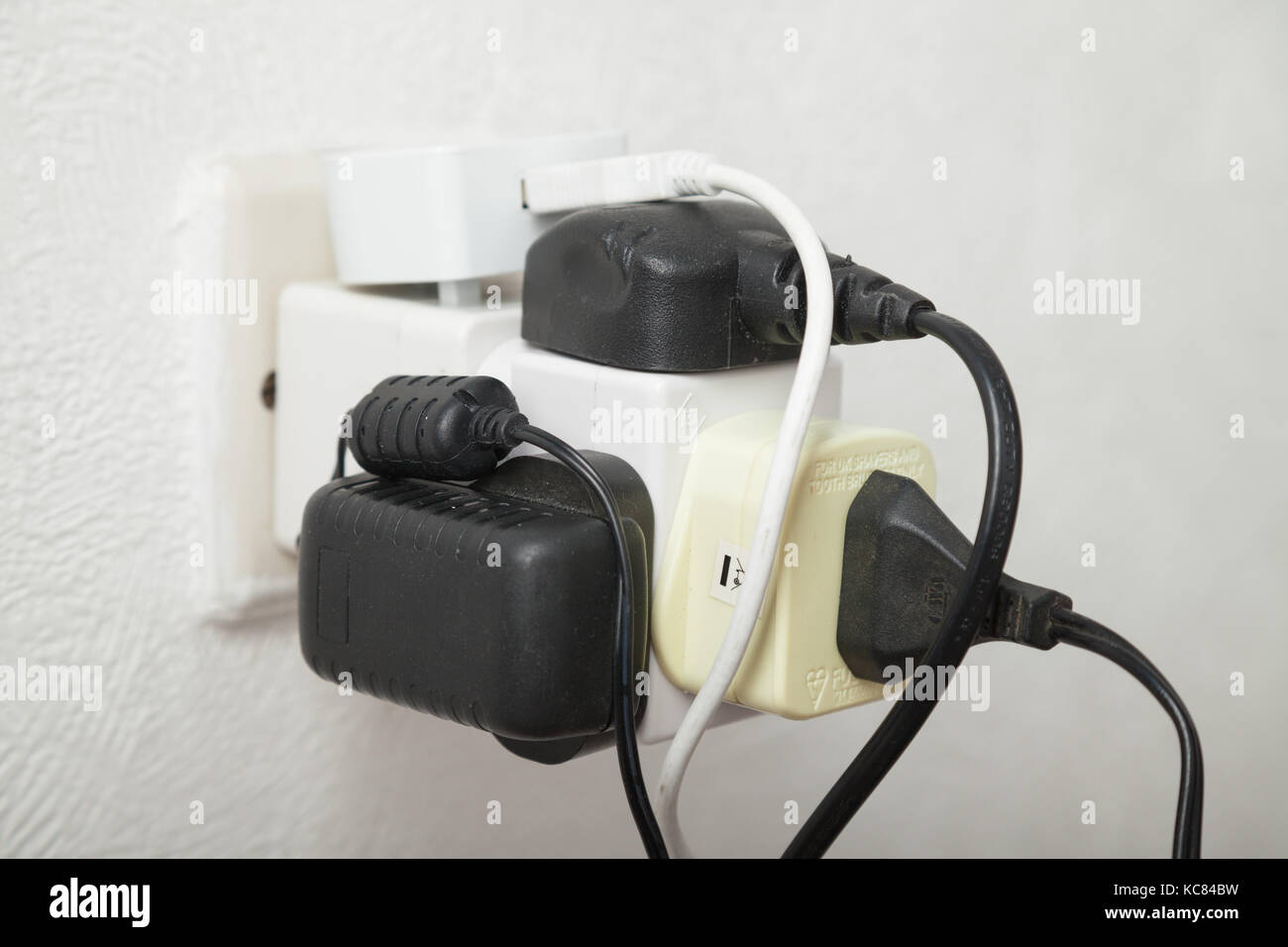 Close up of a overloaded household electrical socket. Stock Photo