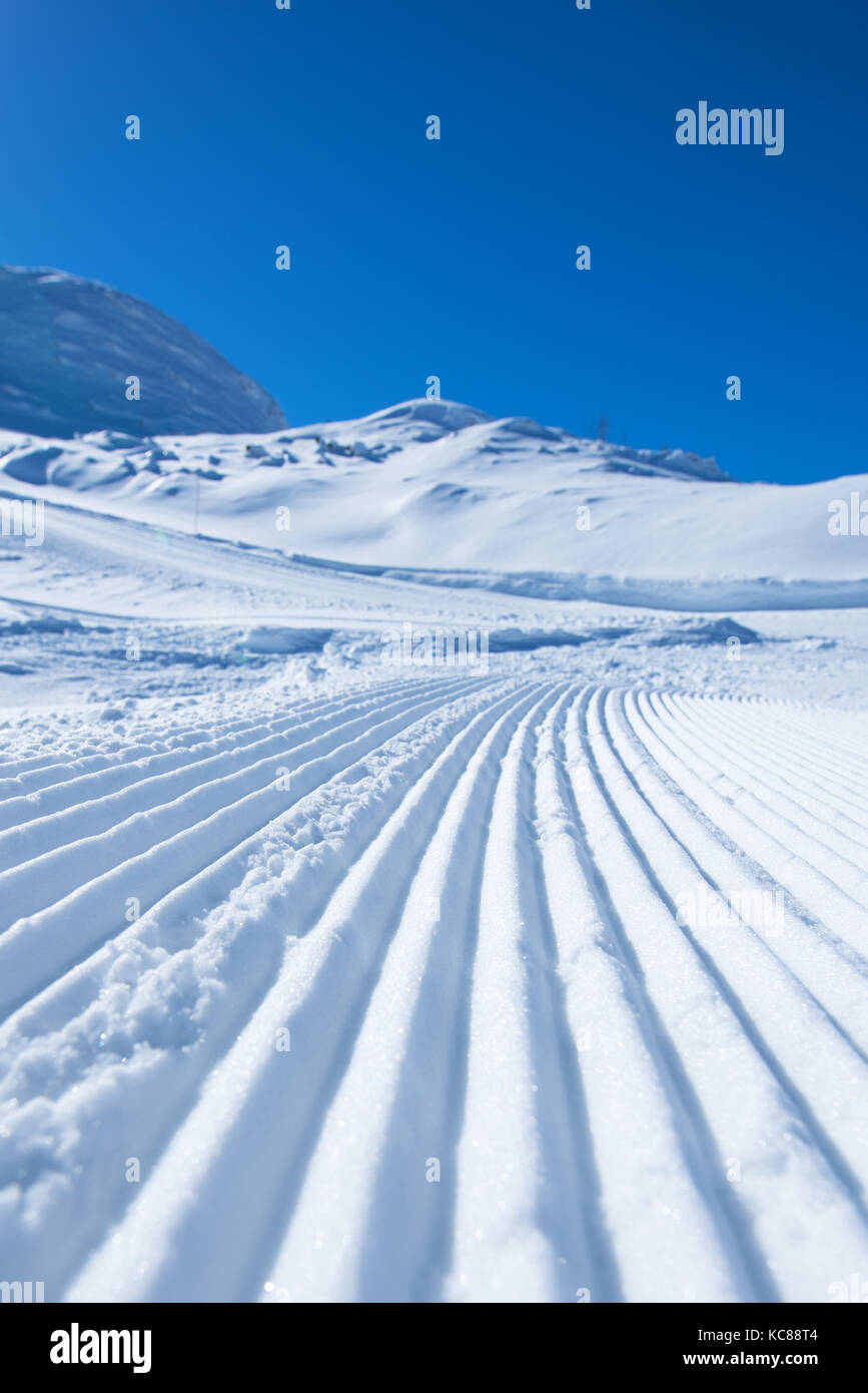 Groomed ski run track in snow, winter season background Stock Photo