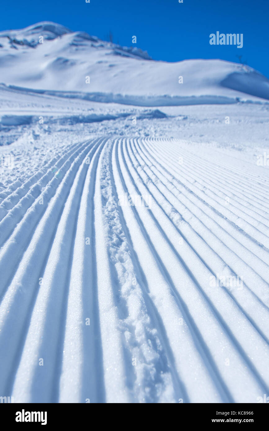 Snow path ski track surface, corduroy texture, selective focus Stock Photo
