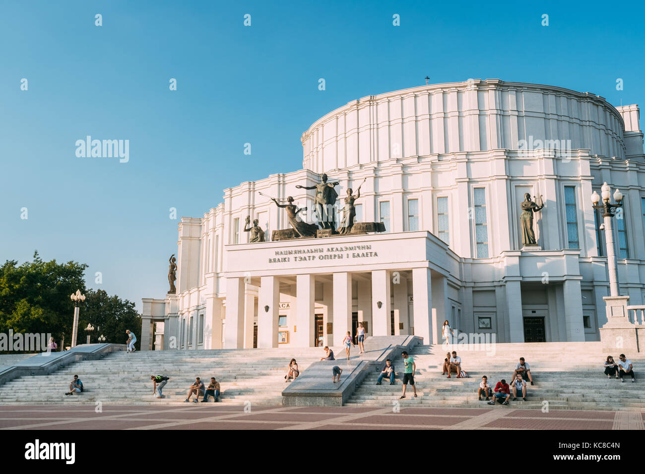 Minsk Belarus. Main Facade Of National Academic Grand Opera Ballet Theatre, White Building Of Constructivist Style Decorated By Sculptures. Resting Yo Stock Photo