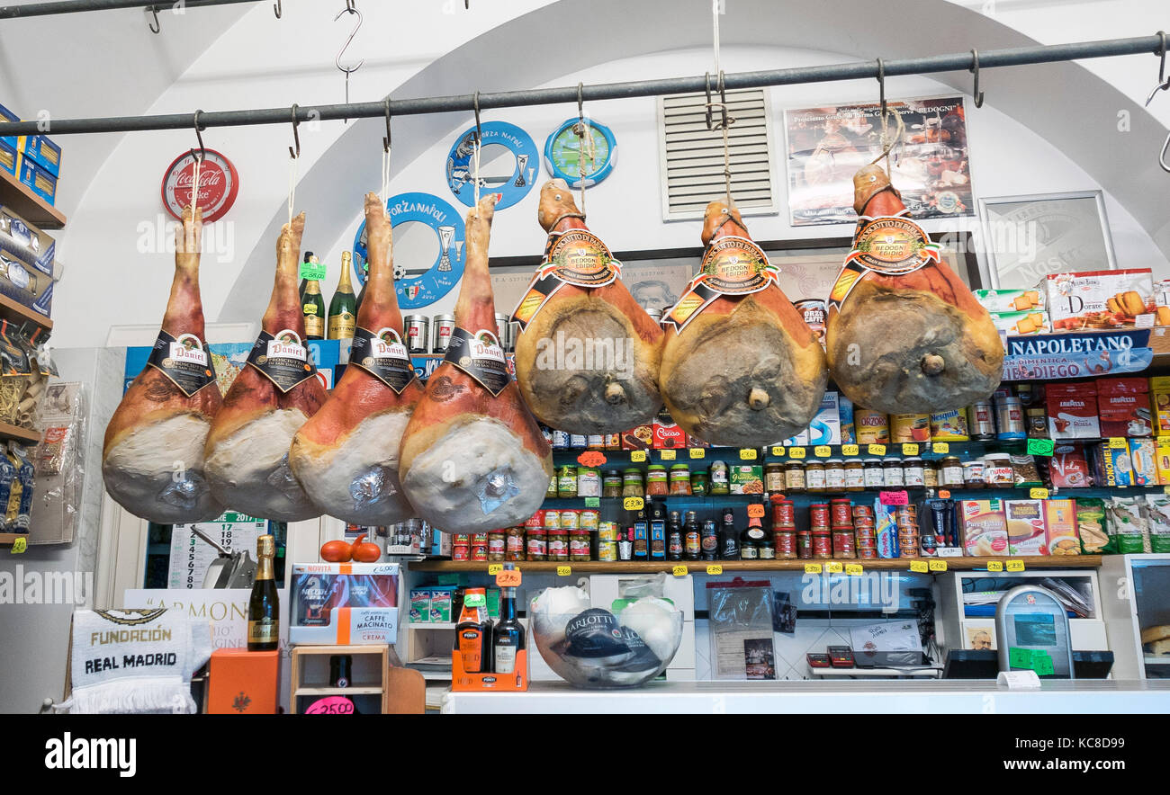 Cured meats hanging in a delicatessen shop in Amalfi  Italy Stock Photo