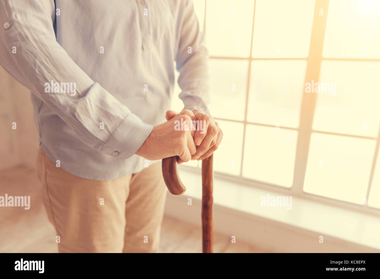 Close up of a senior woman holding a walking stick Stock Photo