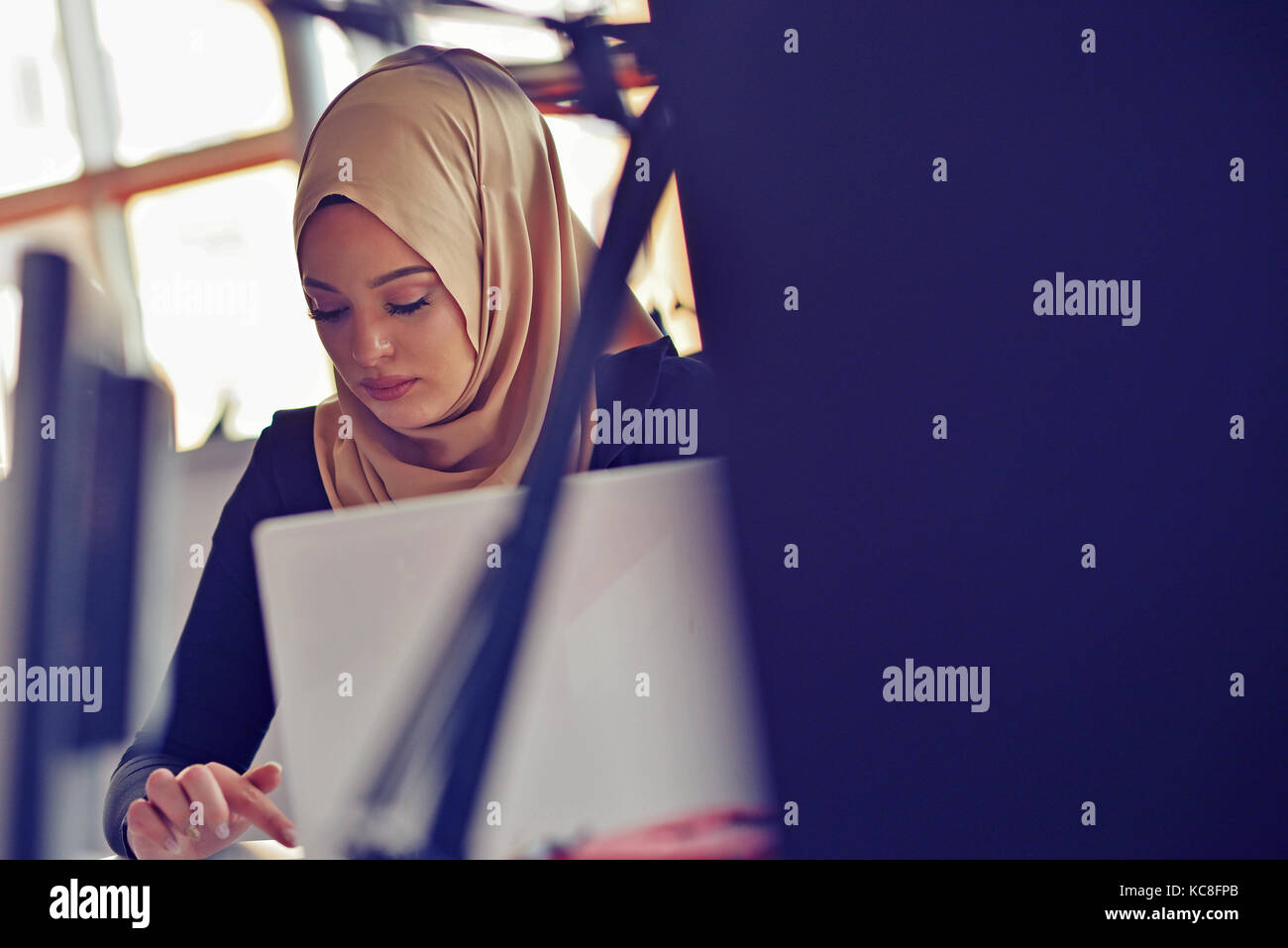 Muslim asian woman working in office with laptop Stock Photo - Alamy