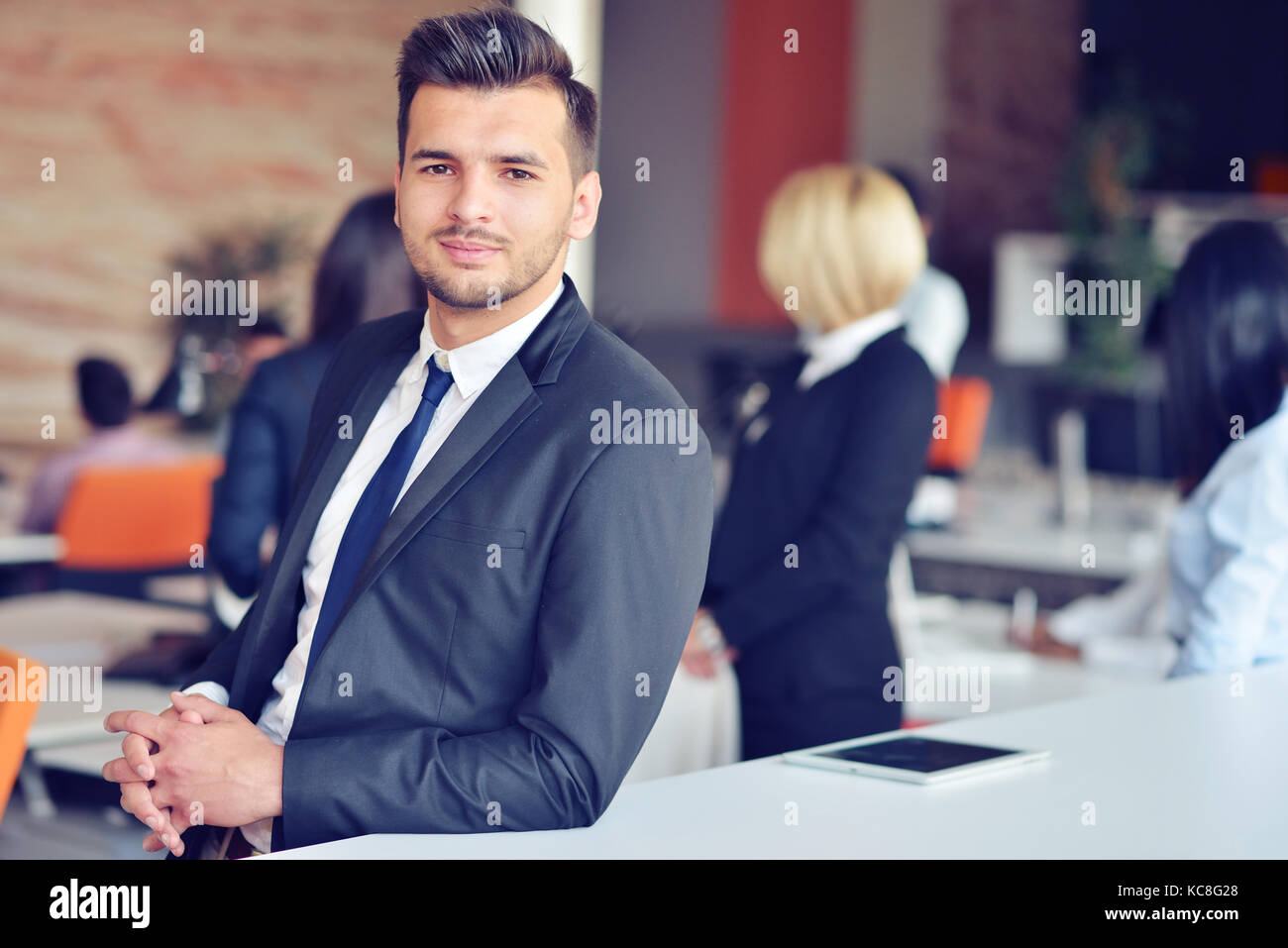 Portrait of an handsome businessman in front of his team Stock Photo ...