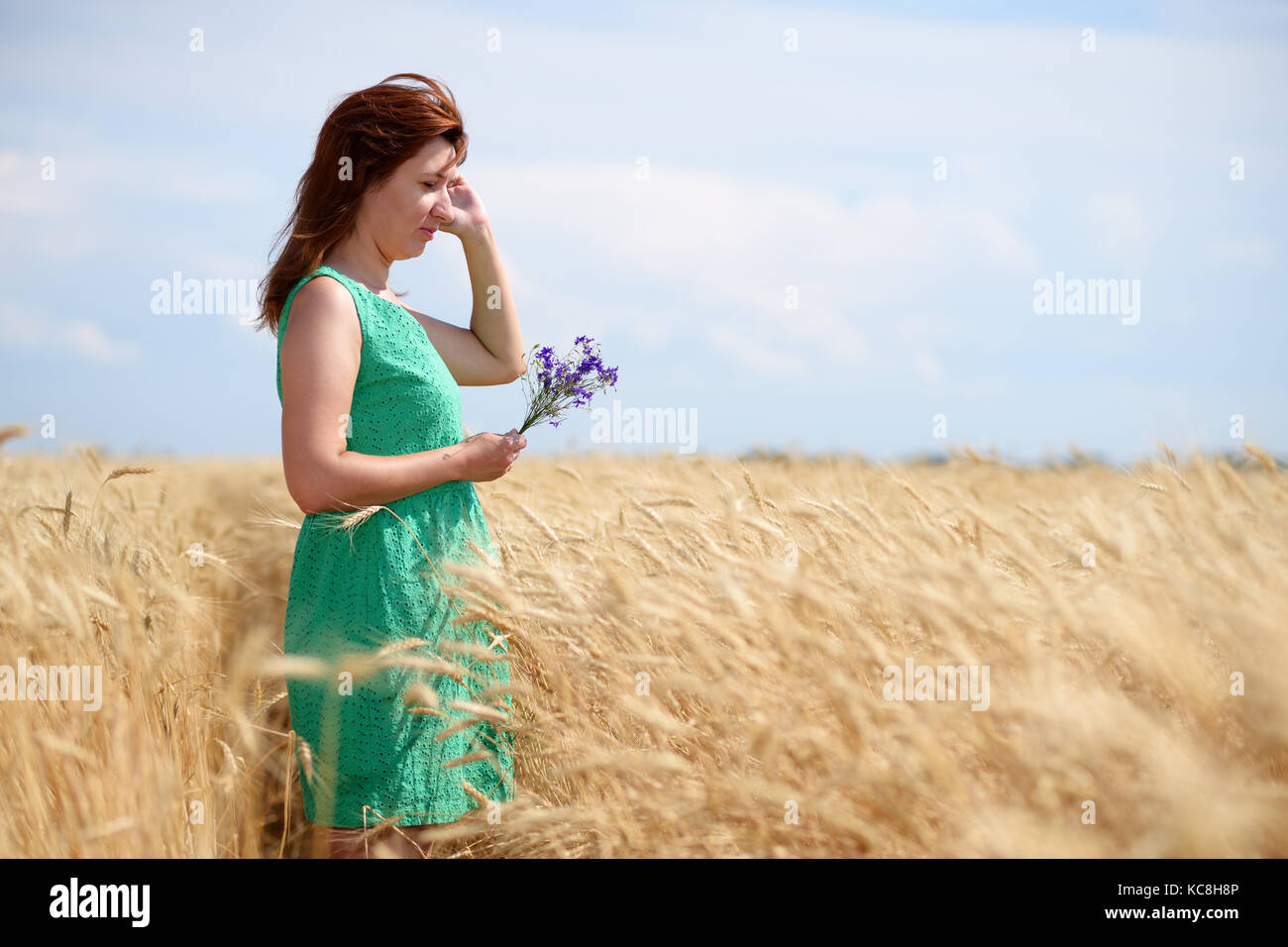 Woman on golden wheat field Stock Photo - Alamy